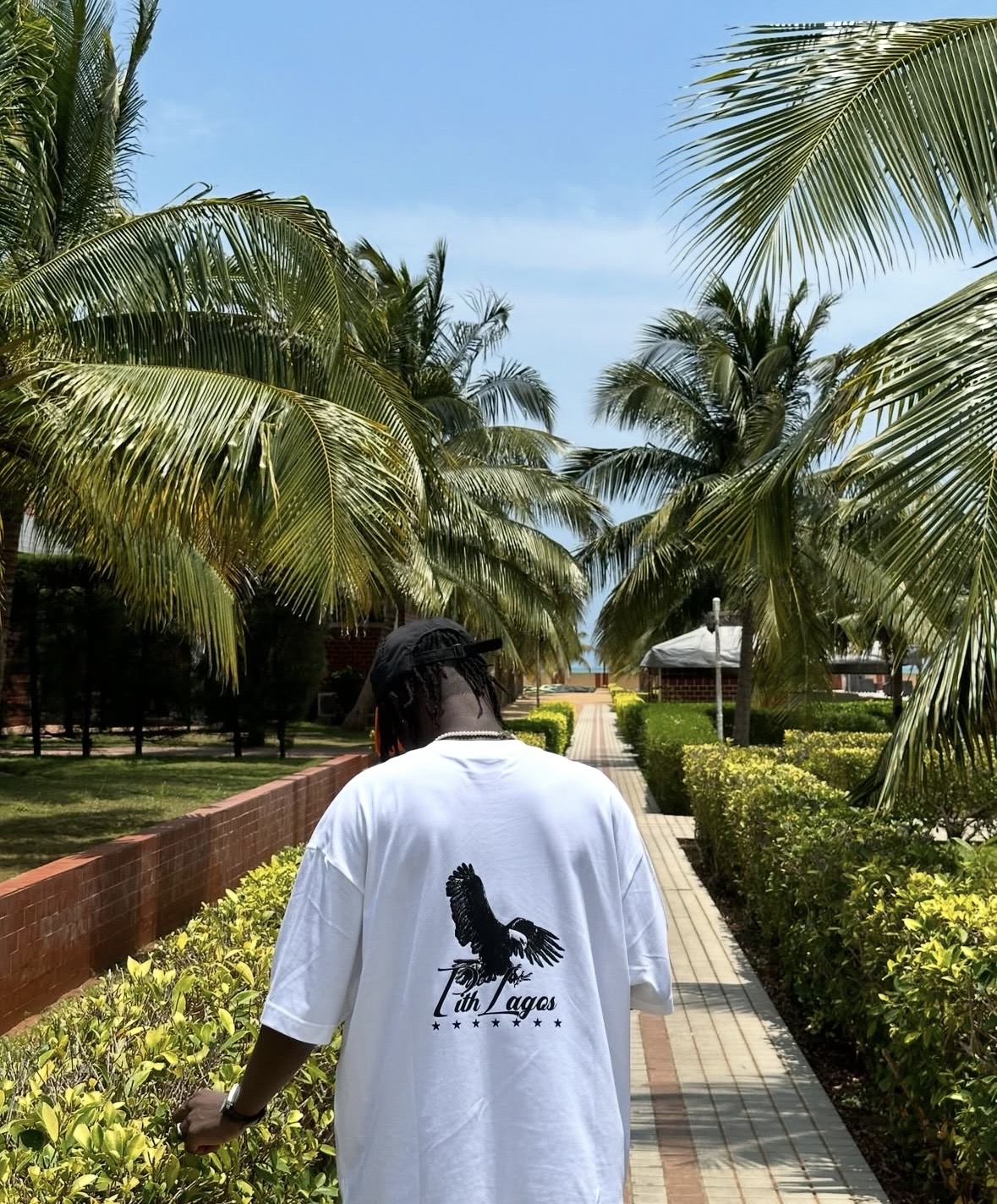 Prince on a palm-lined path in Lagos